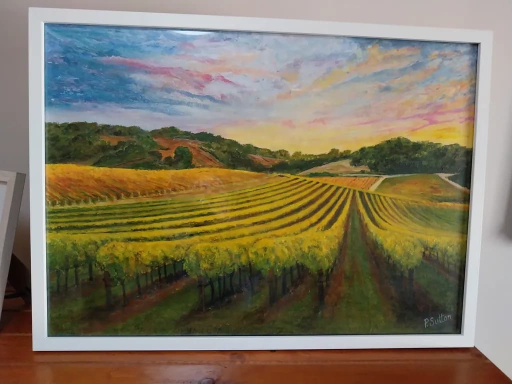 Golden Vineyards at Dusk: A Serene Landscape of Colorful Skies and Lush Scenery