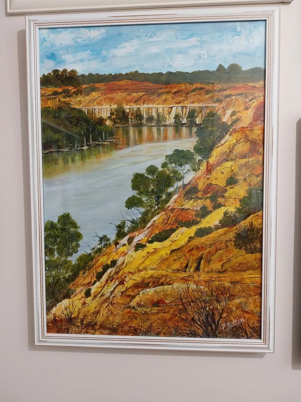 Serenity by the River: A Vibrant Landscape of Cliffs and Trees