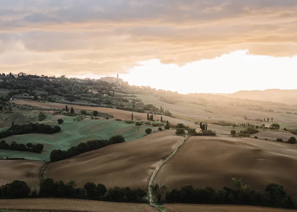Serenity at Dusk: A Tranquil Sunset Over Rolling Hills in the Countryside