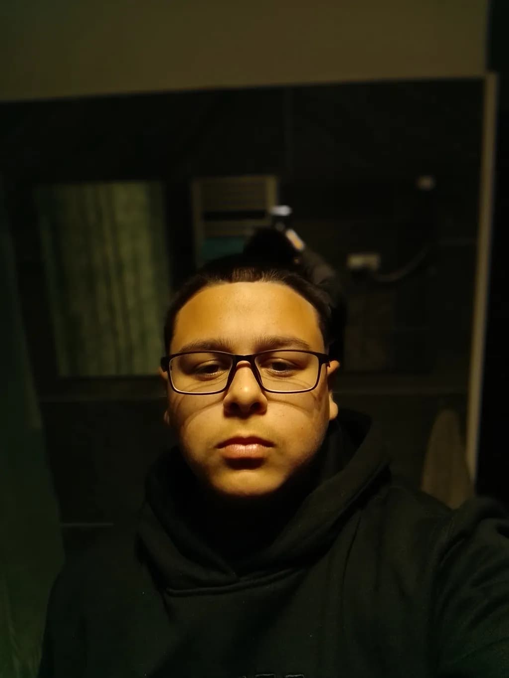 Reflections of Introspection: A Serious Portrait in Glasses and Hoodie