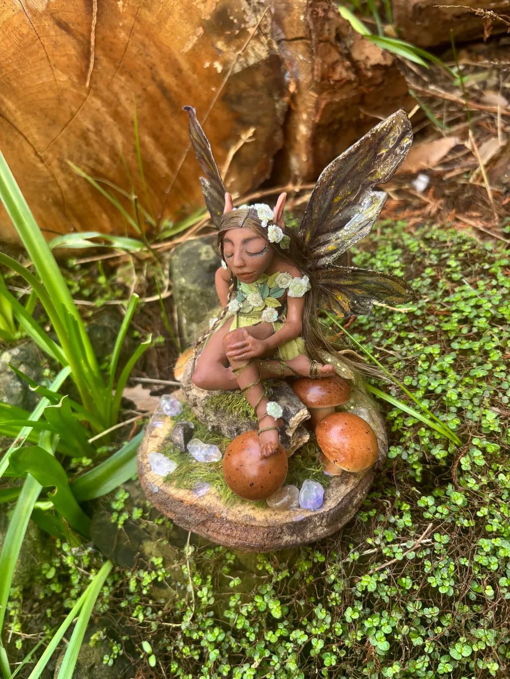 Whispers of the Enchanted Grove: A Serene Fairy Sculpture Amidst Nature's Embrace