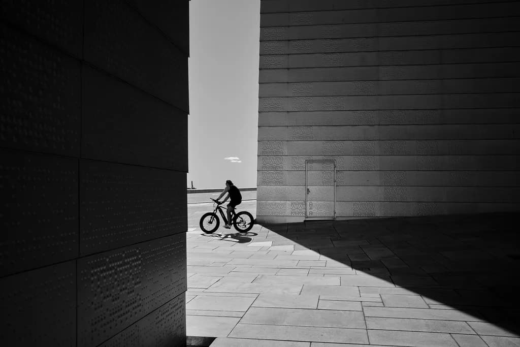 Urban Shadows: A Cyclist's Journey Through Light and Form