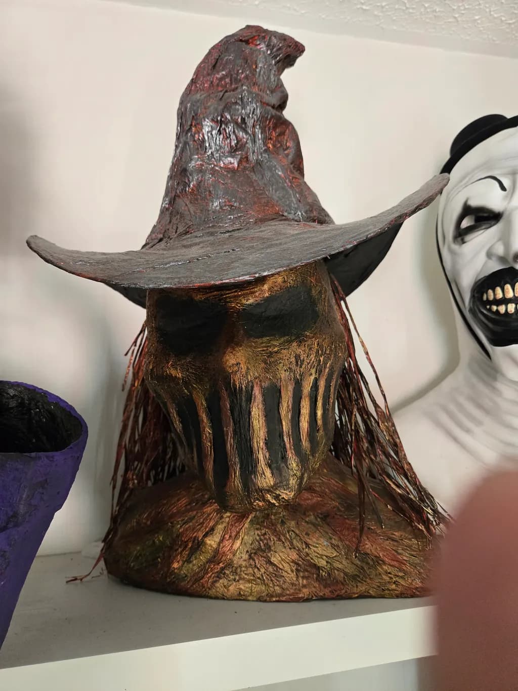 Haunting Elegance: The Enigmatic Scarecrow Sculpture with a Mystical Hat