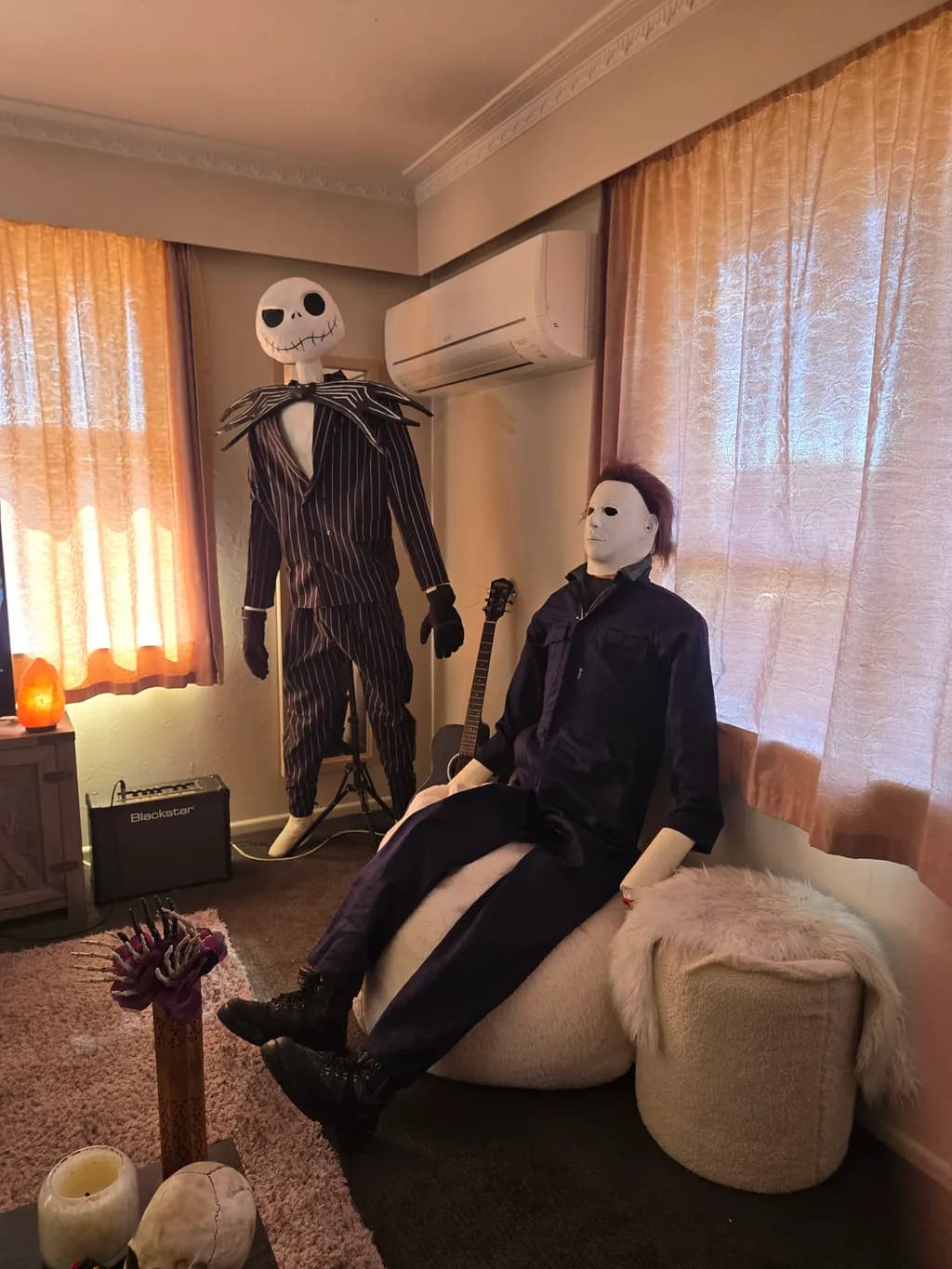 Eerie Companions: A Hauntingly Charming Display of Iconic Horror Figures in a Cozy Setting