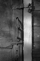 Whispers of Time: The Silent Guardian of the Weathered Door