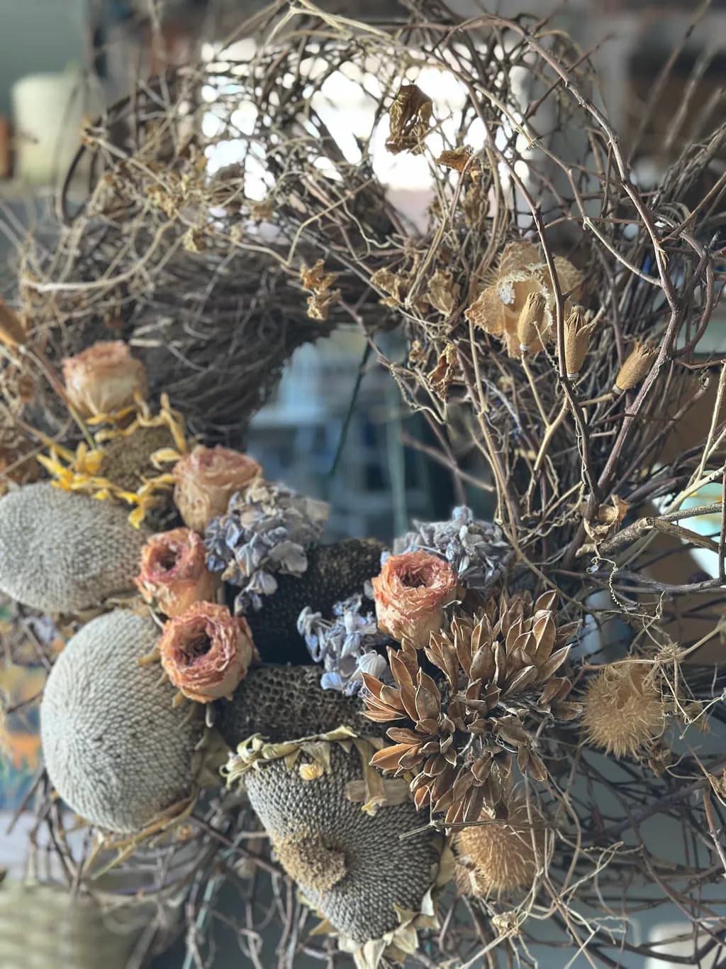 Whimsical Nature's Embrace: A Textured Wreath of Dried Florals and Twisted Vines