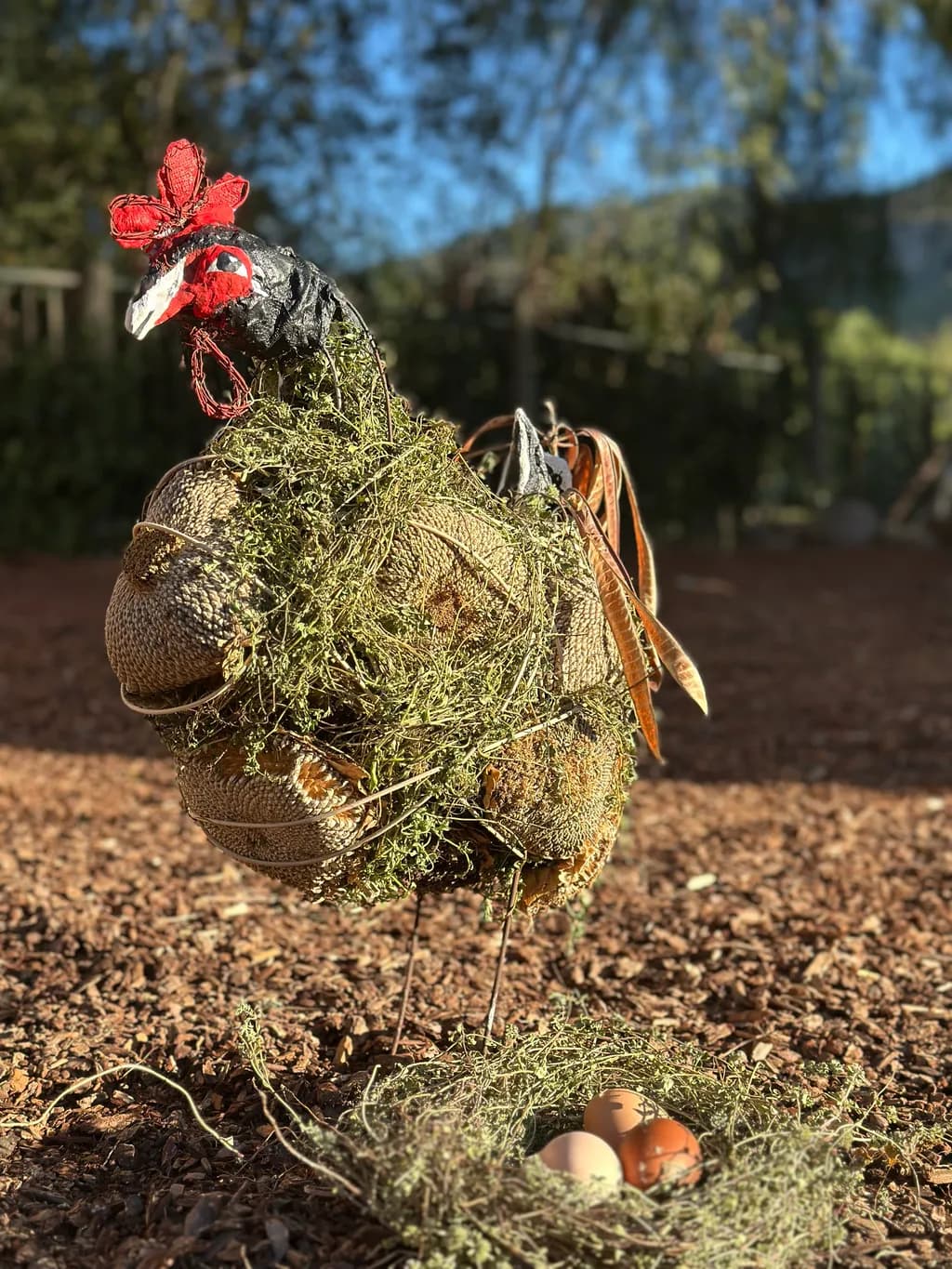 Whimsical Hen Sculpture Nestled in Nature's Embrace: A Unique Art Piece Celebrating Farm Life and Creativity