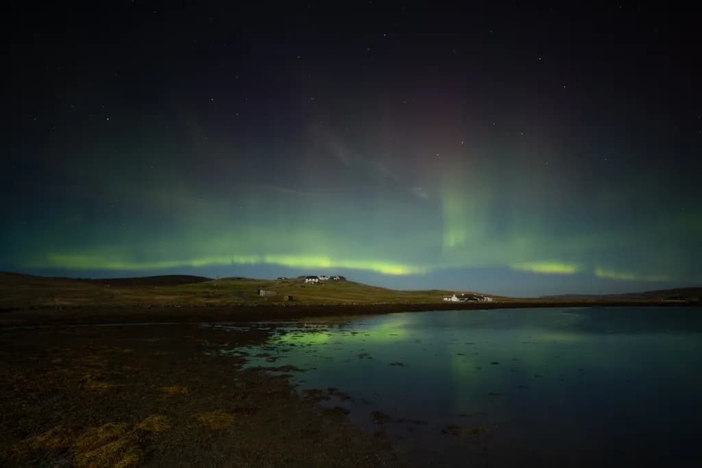 Whispers of the Aurora: A Serene Night Over the Reflective Waters