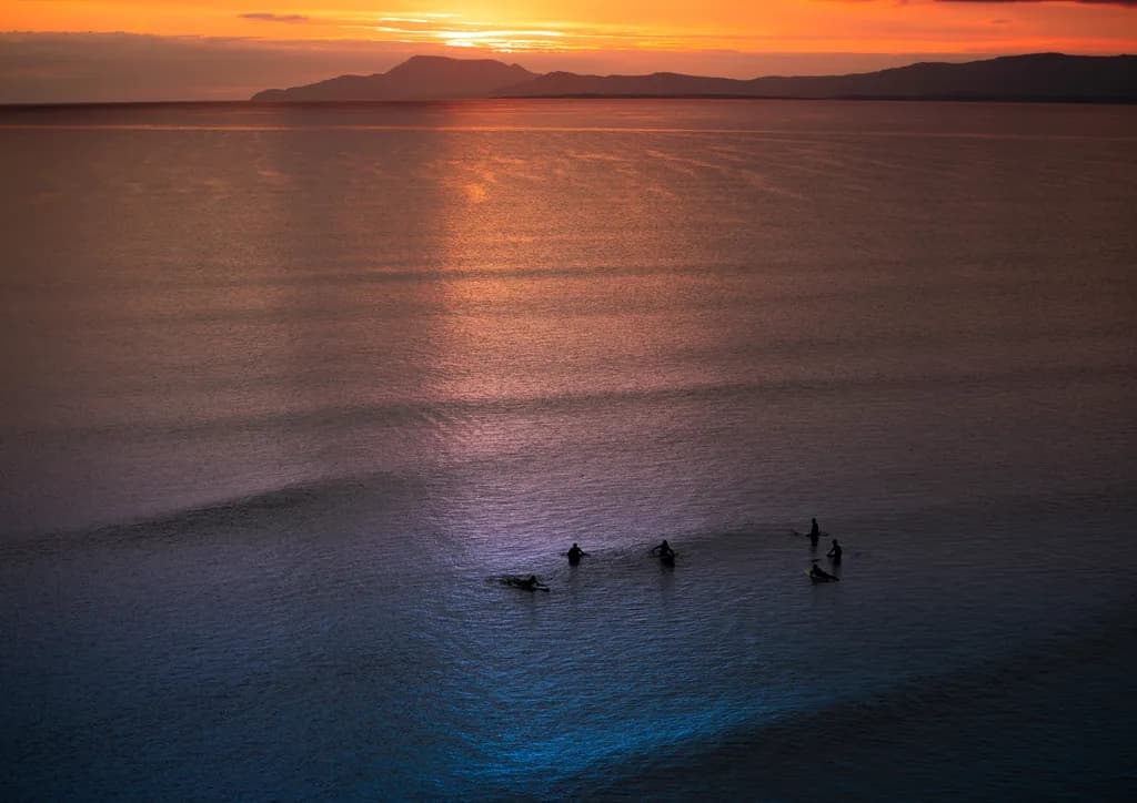 Serenity at Dusk: Fishermen Embrace the Twilight Waters