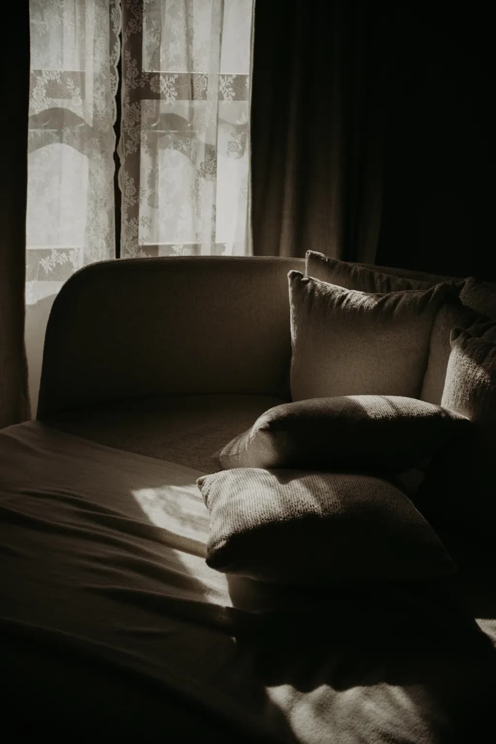 Whispers of Light: A Serene Corner Embraced by Shadows and Soft Textures