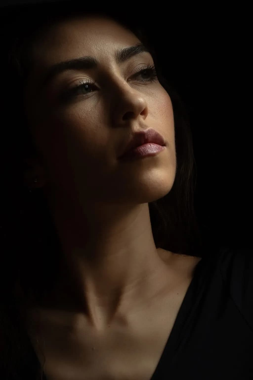 Ethereal Elegance: A Portrait of Contemplation in Shadows