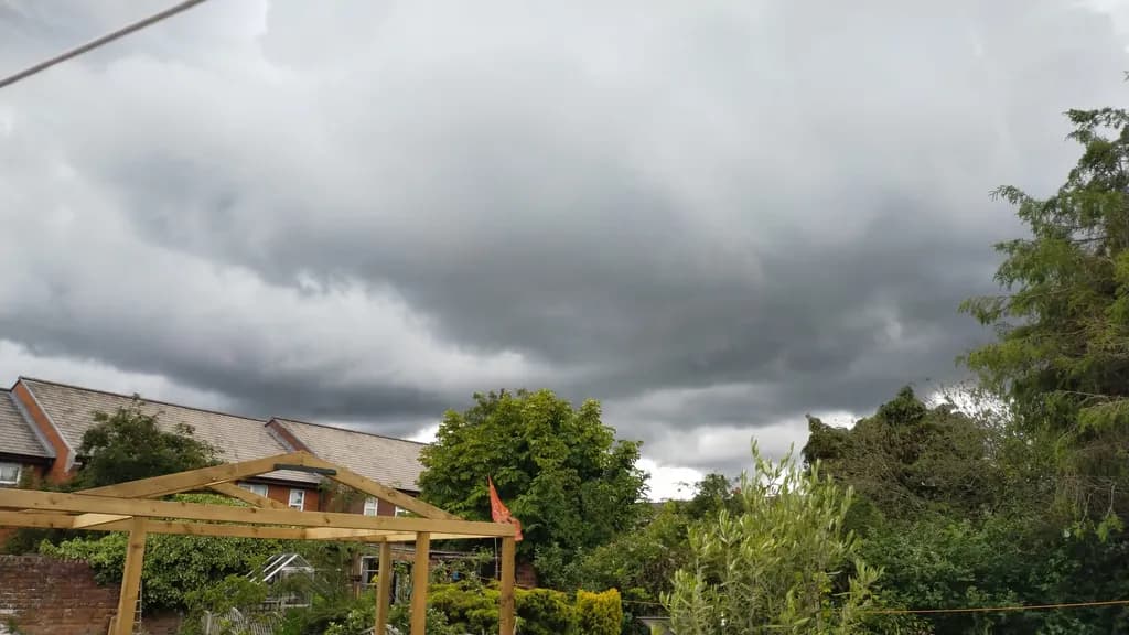 Whispers of an Approaching Storm: A Dramatic Sky Over Lush Greenery