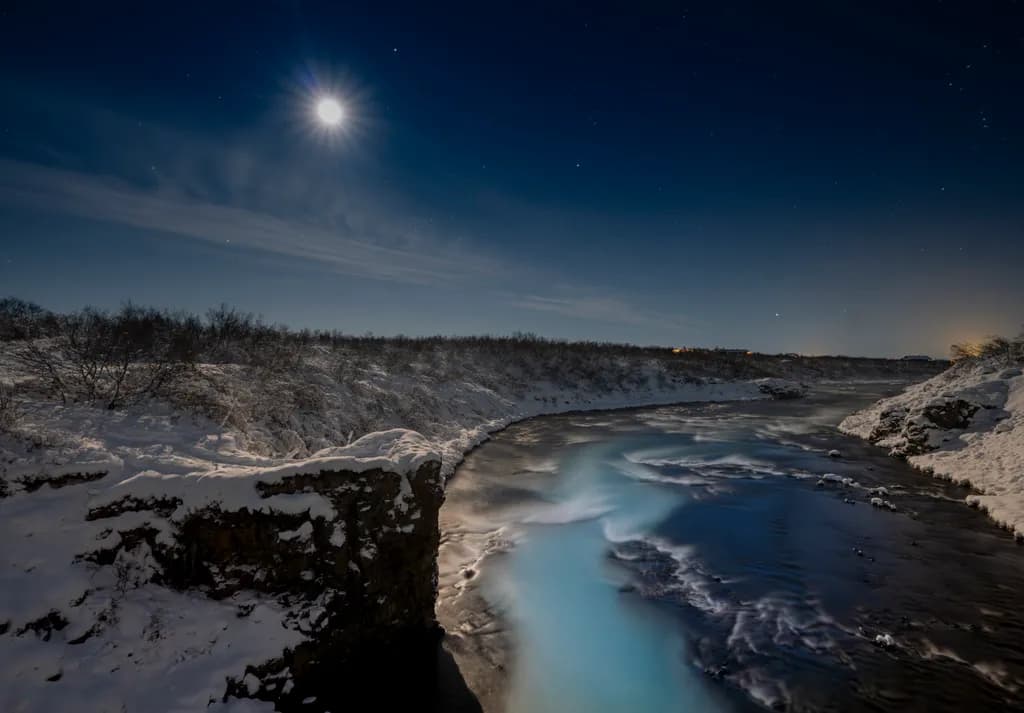Moonlit Serenity: A Winter's Embrace Over the Frozen River