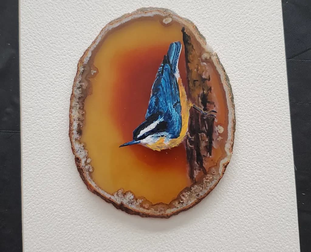 Whispers of Nature: A Bluebird's Embrace on Agate Slice