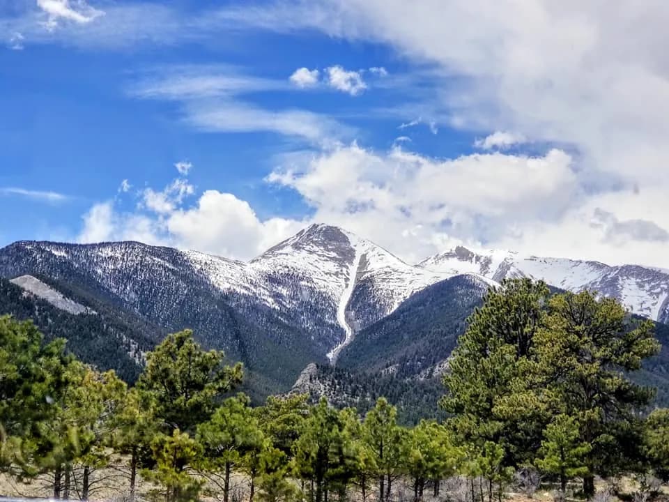 Majestic Peaks: A Serene Mountain Landscape Under a Vast Blue Sky