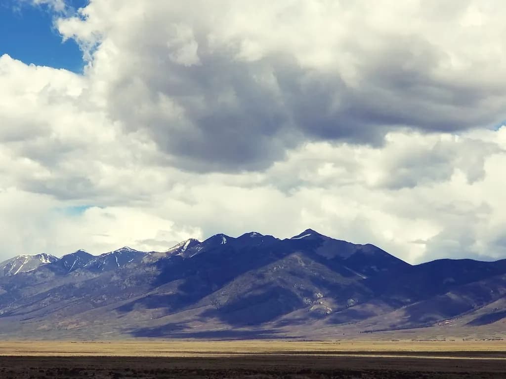 Majestic Peaks Under a Dramatic Sky: A Serene Landscape Capture