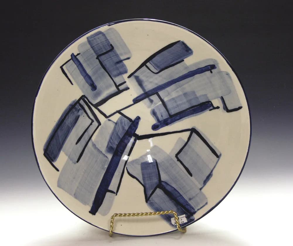 Abstract Harmony: A Handcrafted Ceramic Plate with Bold Blue Brushstrokes