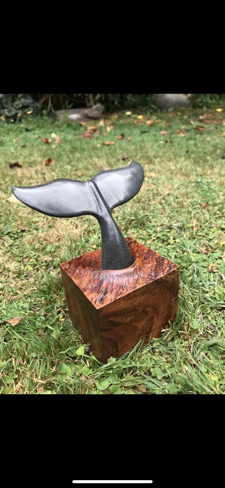 Whale's Embrace: A Serene Stone Sculpture on Natural Wood Base