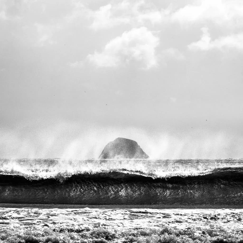 Whispers of the Ocean: A Monochrome Dance of Waves and Rock