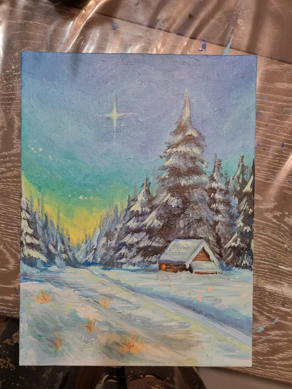 Serene Winter Night: A Starry Landscape with Snow-Covered Trees and a Cozy Cabin