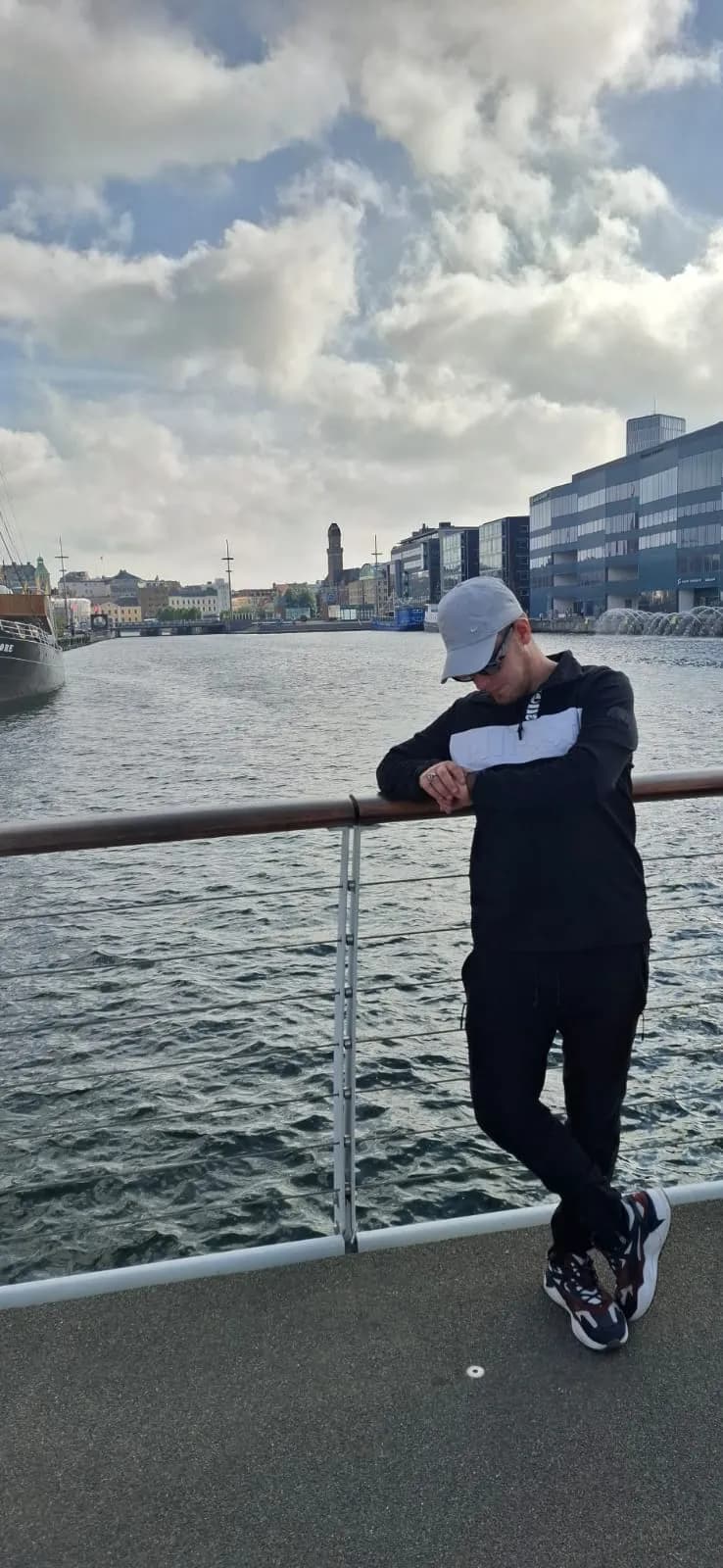 Urban Reflections: A Moment of Contemplation by the Water's Edge