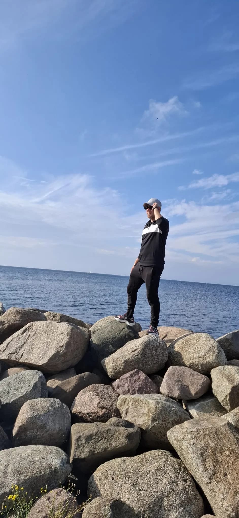 Serenity on the Shore: A Casual Stroll Among the Rocks and Waves