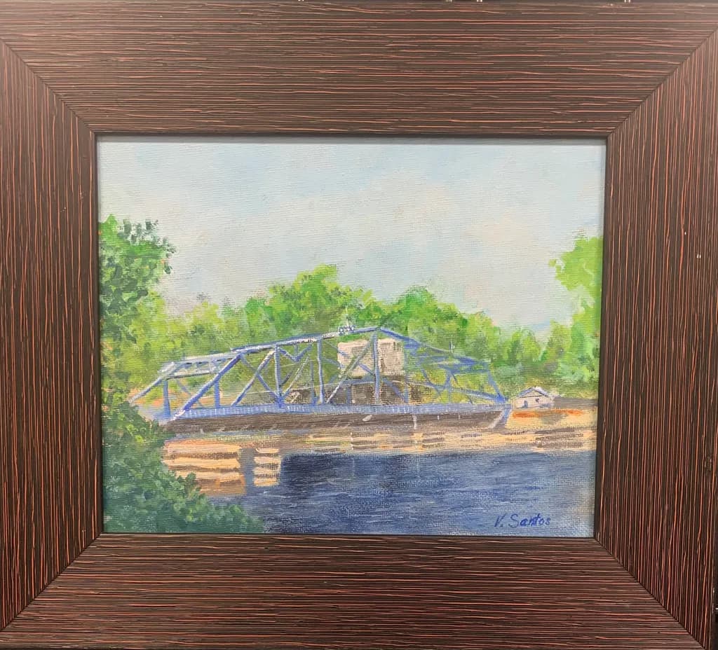 Bridging Serenity: A Tranquil River Scene with a Blue Structure Amidst Lush Greenery