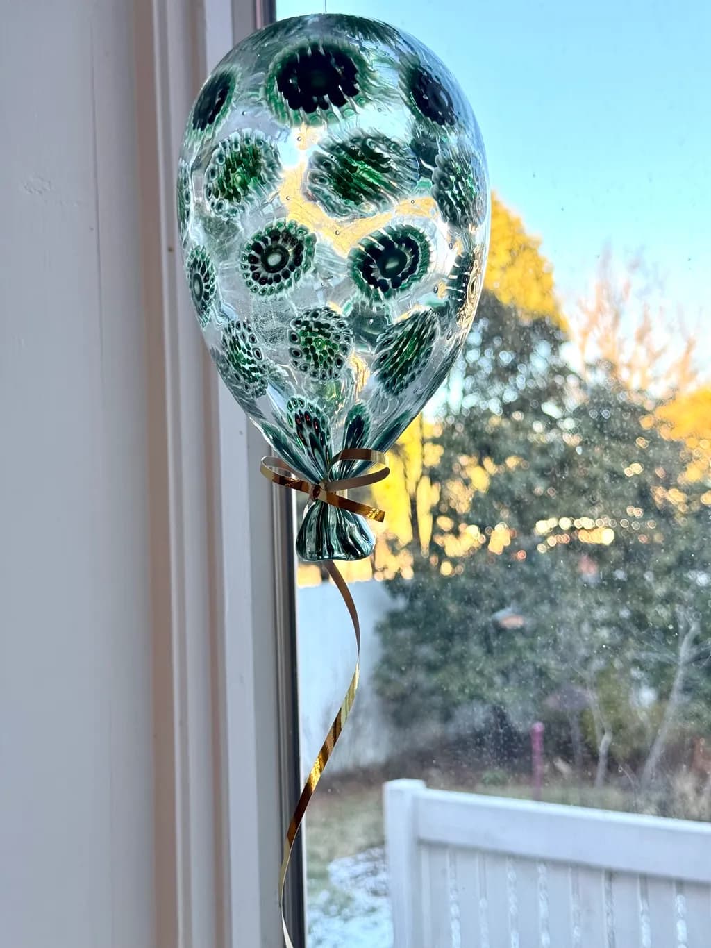 Whimsical Green Glass Balloon: A Decorative Window Delight