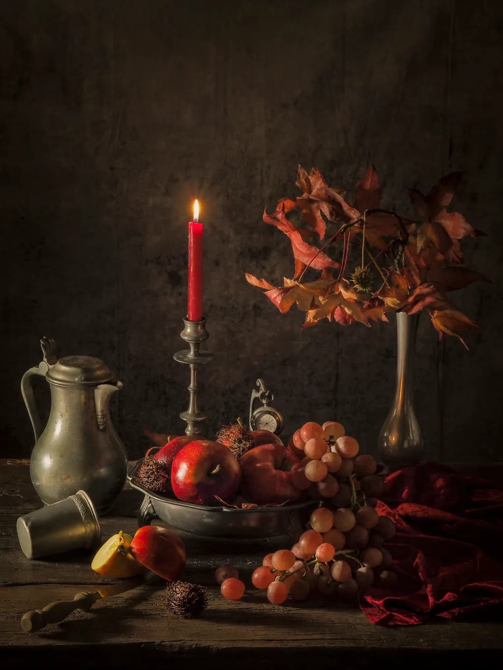 Autumn's Embrace: A Still Life of Apples, Grapes, and Candlelight