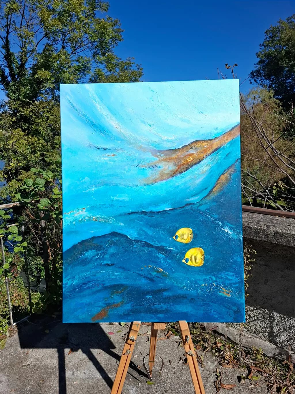 Oceanic Serenity: A Vibrant Dance of Blue and Yellow Fishes in a Tranquil Landscape Canvas