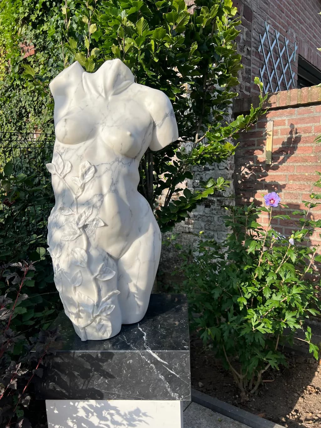 Ethereal Elegance: A Marble Figure Embracing Nature's Beauty