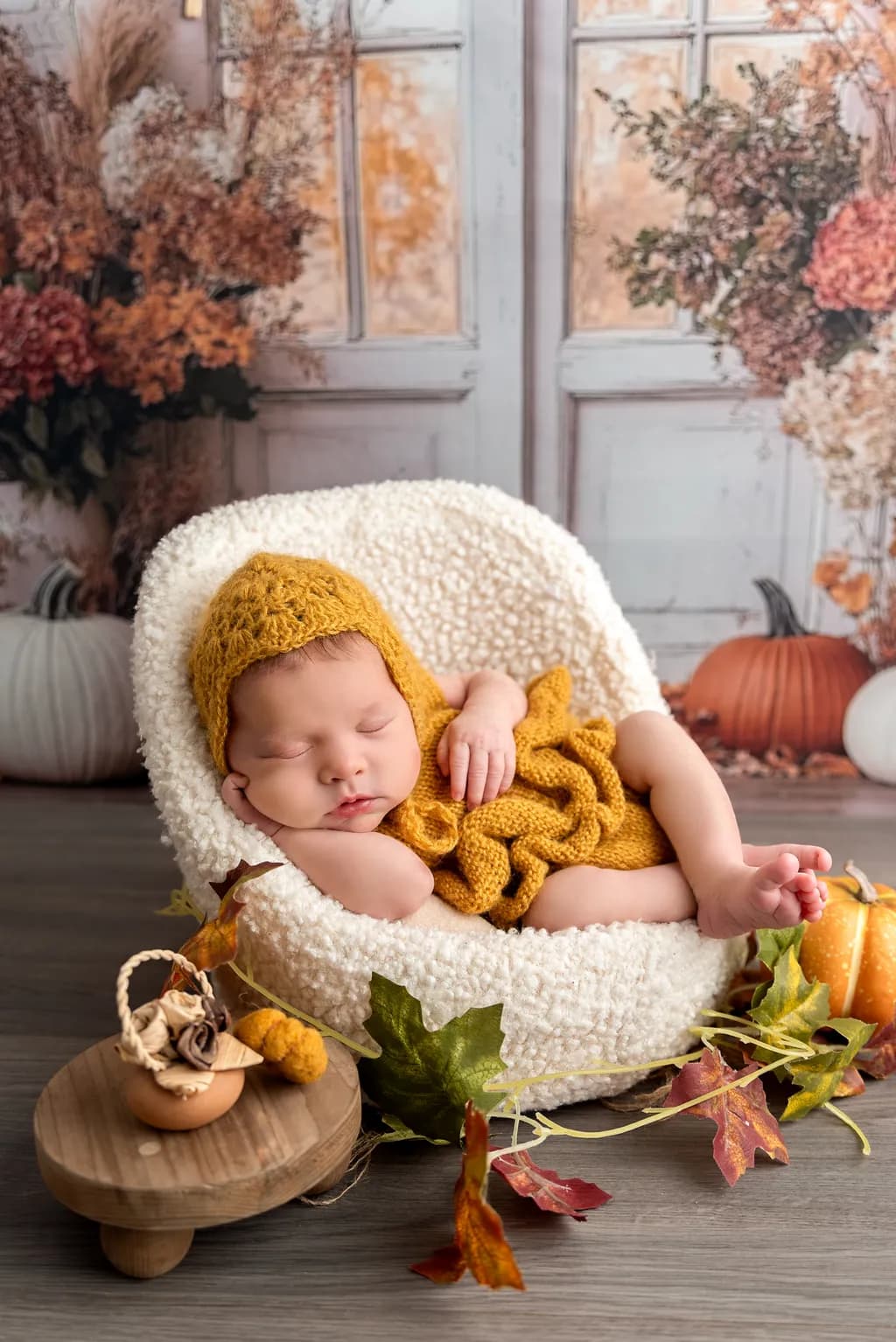Autumn Dreams: A Serene Newborn in Cozy Knitwear Amidst Fall's Embrace