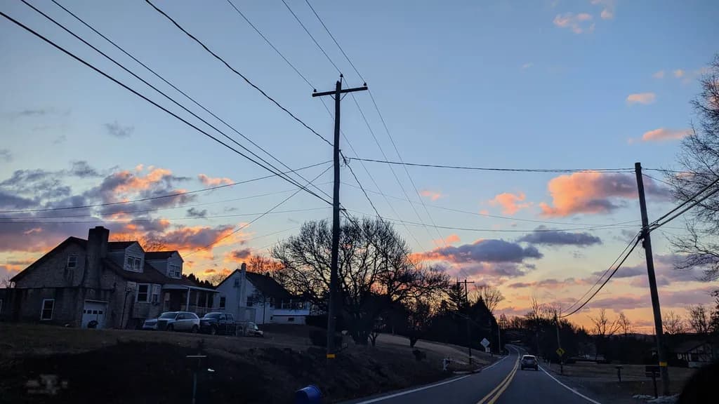 Whispers of Dusk: A Serene Evening Landscape with Power Lines and Pastel Skies