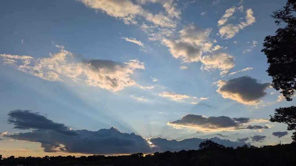 Ethereal Sunset: A Dance of Light and Clouds in the Evening Sky
