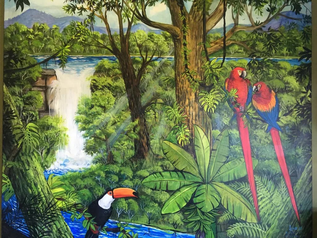 Tropical Symphony: A Vibrant Waterfall Oasis with Parrots and Toucans