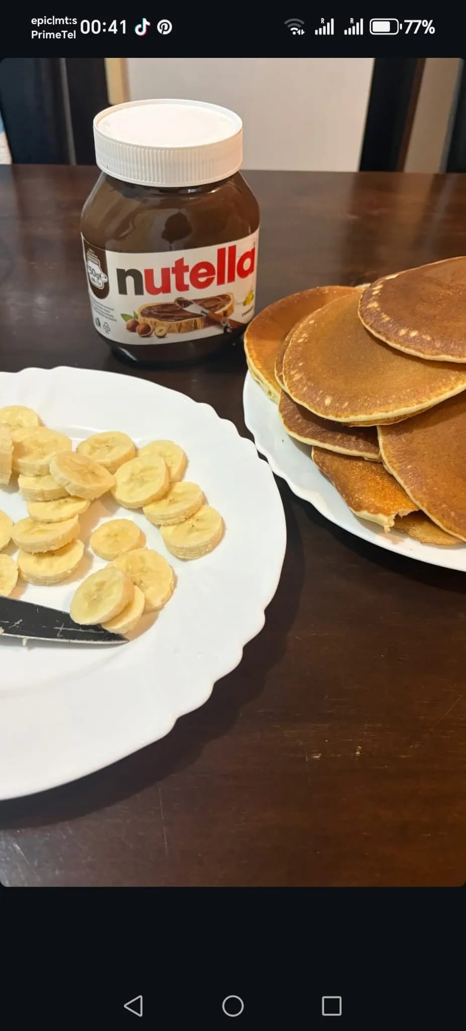 Delightful Morning Indulgence: Fluffy Pancakes with Nutella and Fresh Bananas