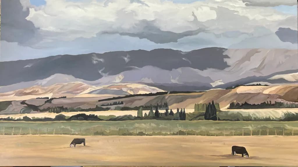 Serenity in Pastoral Landscapes: Cows Grazing Under a Dramatic Sky