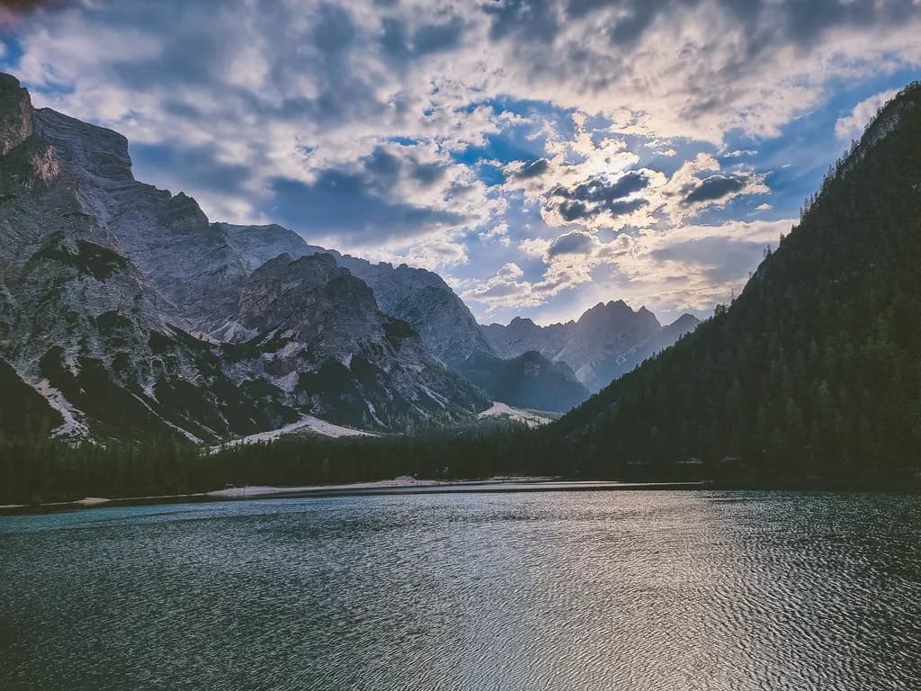 Whispers of Serenity: A Tranquil Lake Amidst Majestic Mountains at Dusk