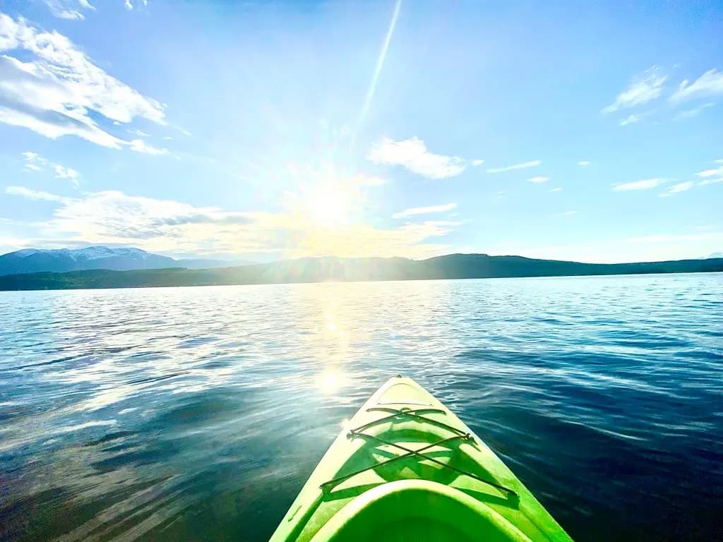 Serenity on the Water: A Kayaker's Journey into the Sunlit Horizon