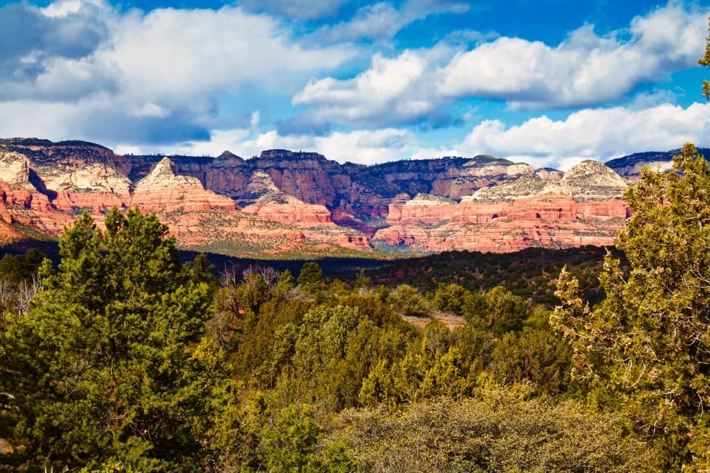Majestic Serenity: A Scenic Landscape of Mountains and Lush Greenery Under a Cloudy Sky