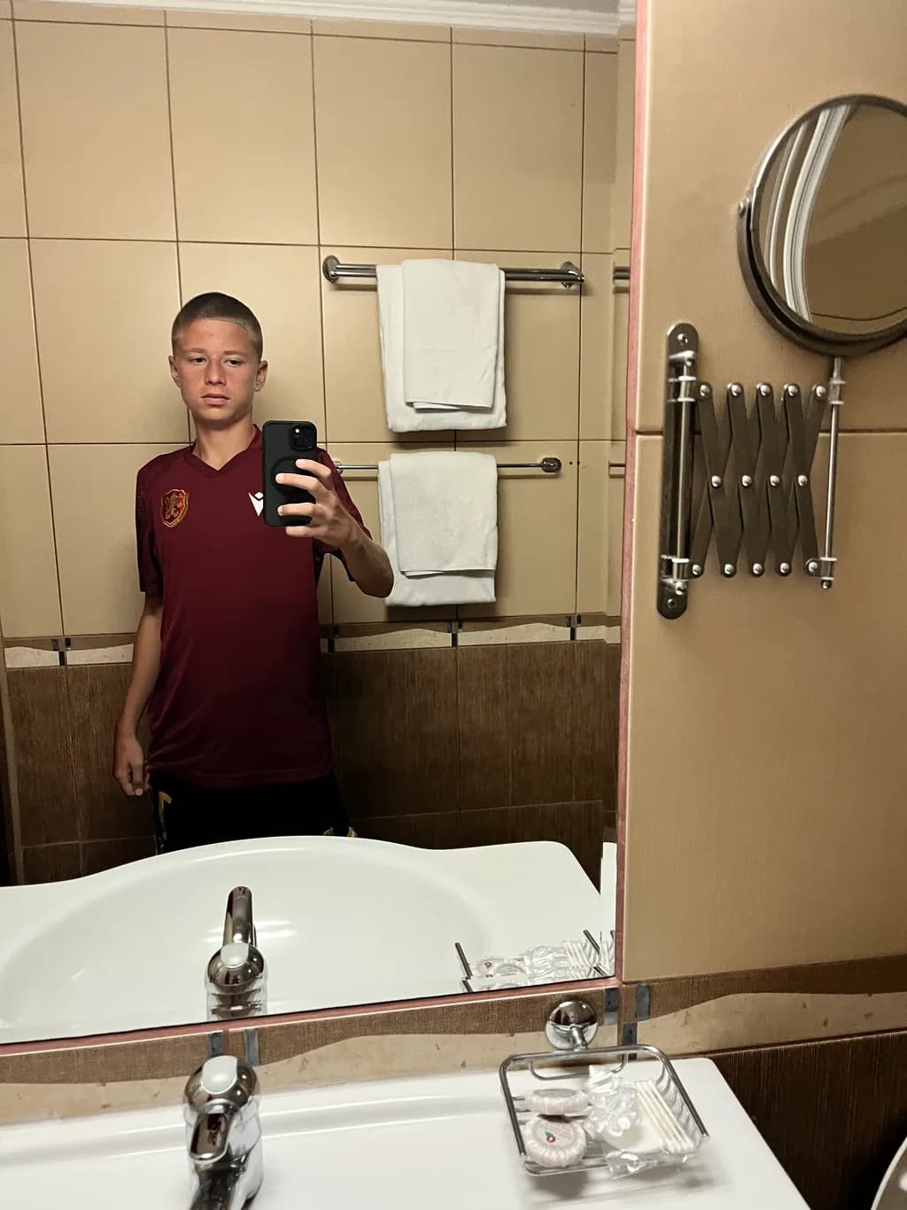 Reflections of Youth: A Casual Bathroom Selfie in Red