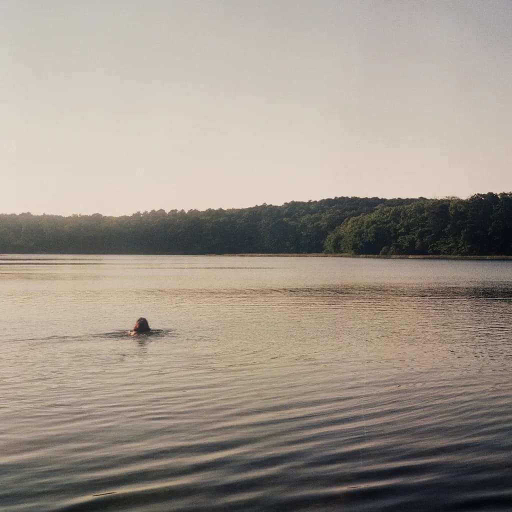 Serenity in the Splash: A Quiet Swim at Dusk