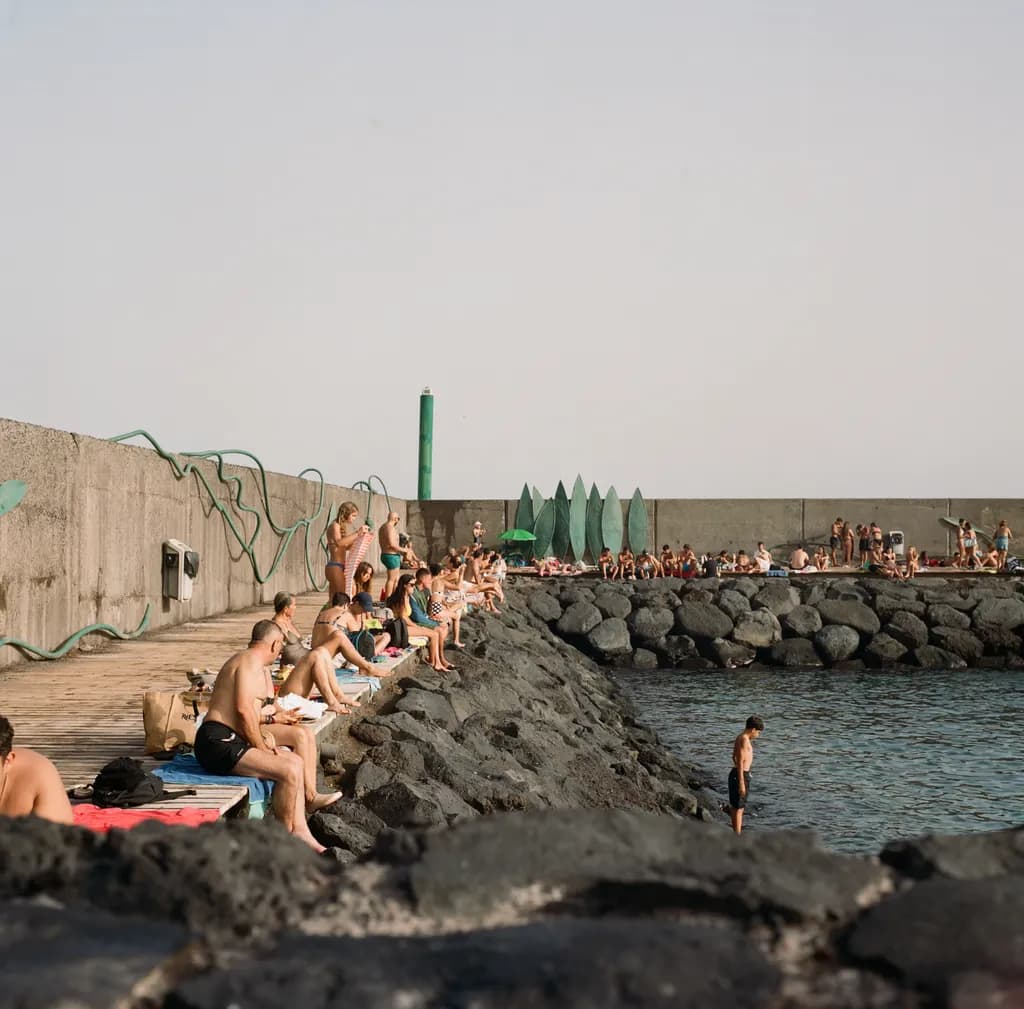 Sunbathers and Splashers: A Relaxed Day by the Water's Edge