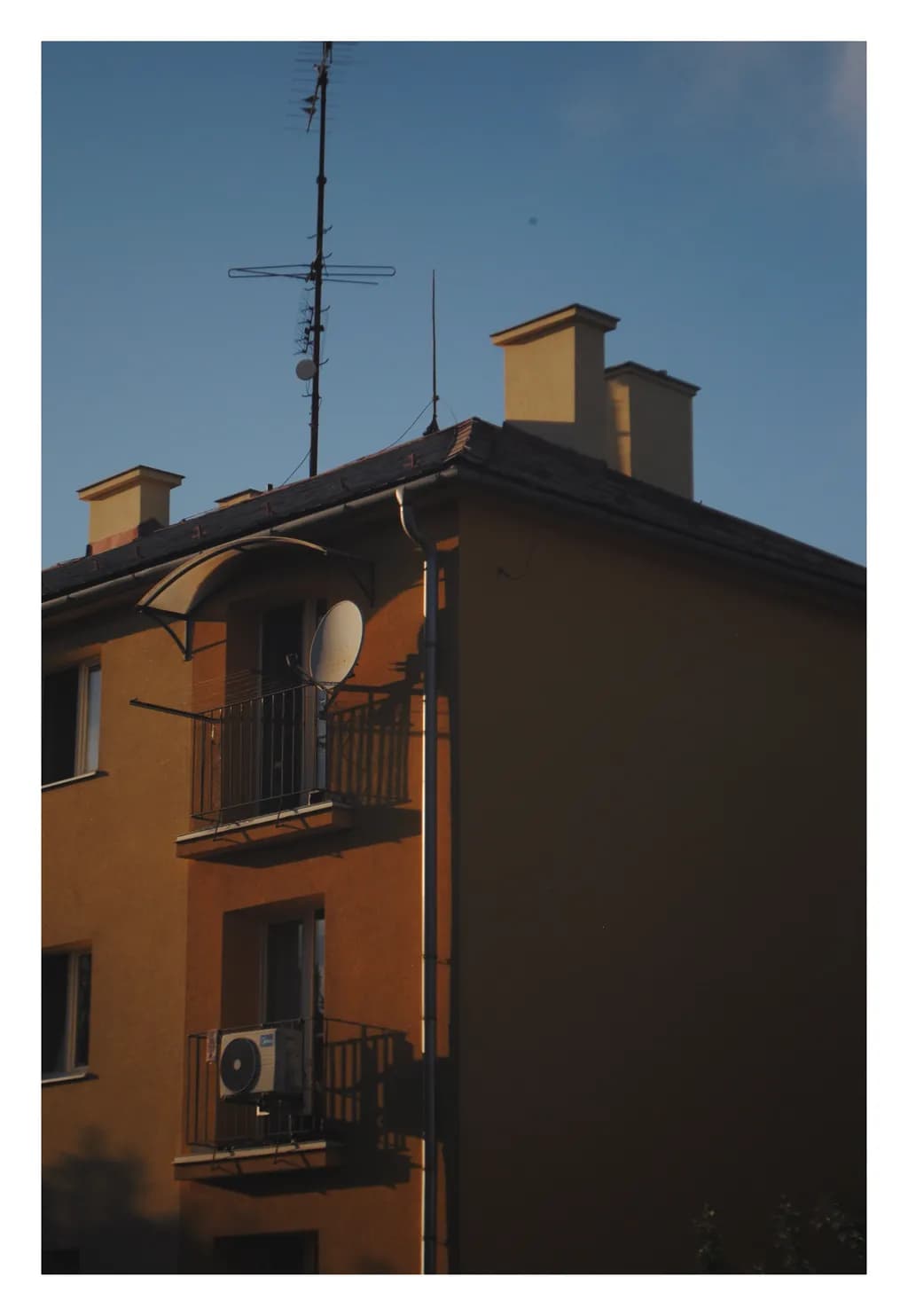Urban Sunset: A Serene Balcony View of Architectural Harmony