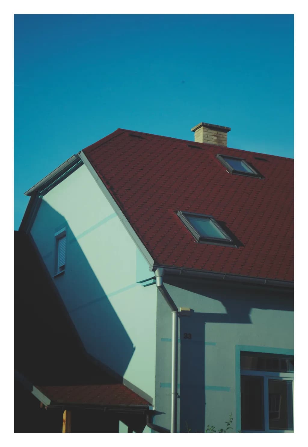 Whispers of Home: A Serene Rooftop Reflection Under a Clear Blue Sky