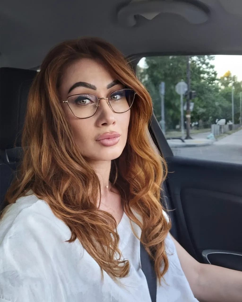 Confident Elegance: A Portrait of Beauty Behind the Wheel
