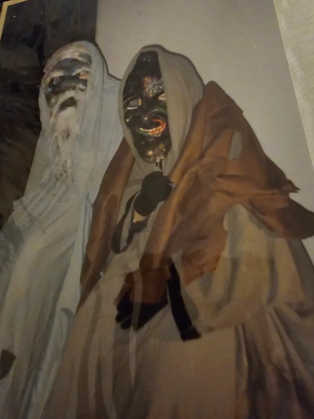 Eerie Masks of Tradition: A Haunting Performance in Costumes