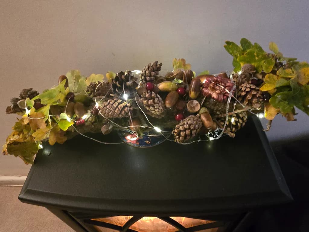 Nature's Glow: A Whimsical Arrangement of Pinecones and Autumn Leaves with Twinkling Lights