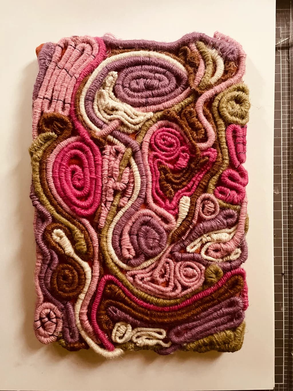 Whimsical Threads: A Tapestry of Spirals and Colors in Pink and Earthy Tones