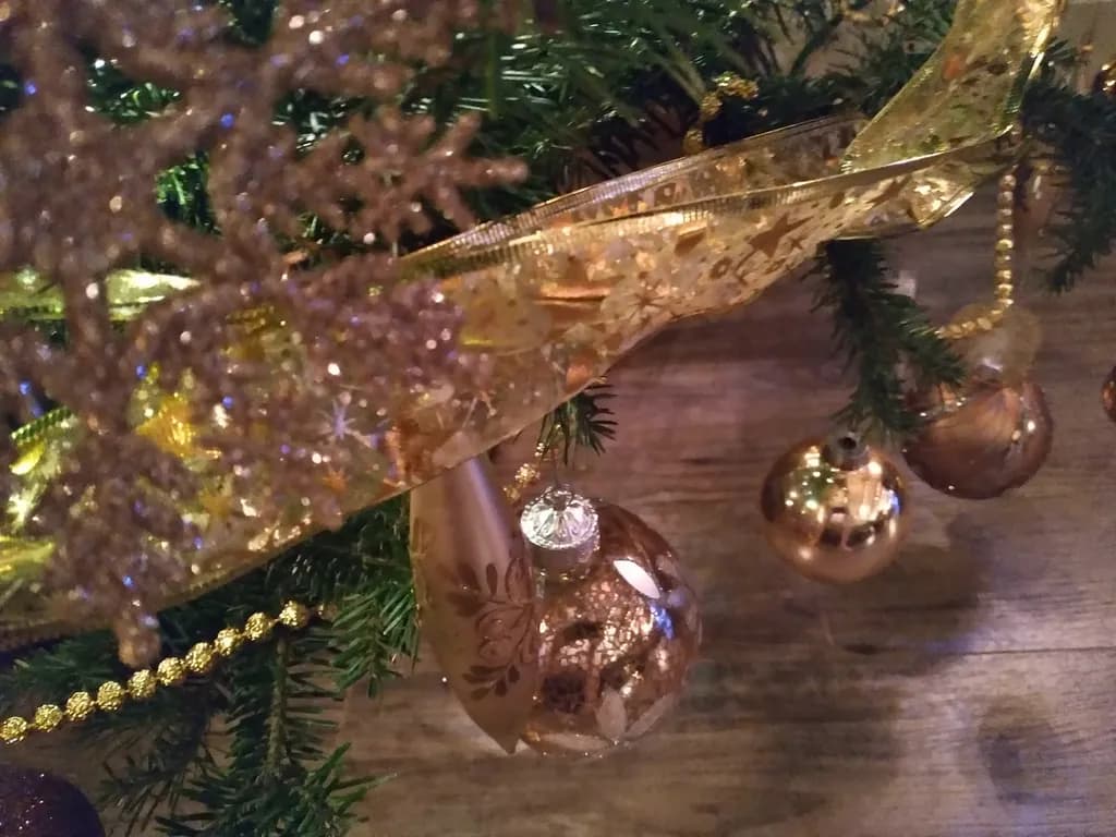 Golden Whispers: A Festive Embrace of Ornaments and Ribbons